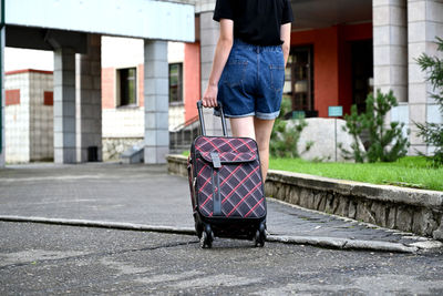 Low section of woman walking on street