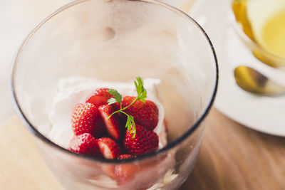 Close-up of strawberries in glass bowl on table