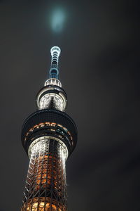 Low angle view of illuminated tower at night