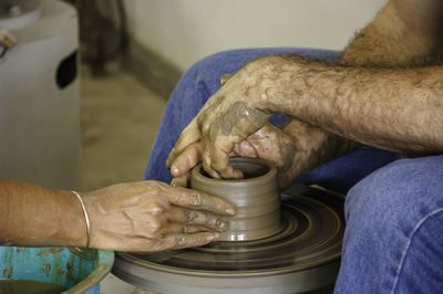 Midsection of man working in mud