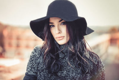 Portrait of beautiful young woman wearing hat