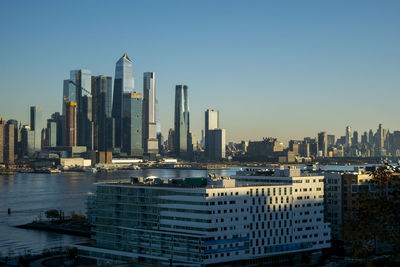 Modern buildings in city against clear sky