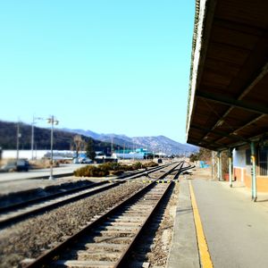 Railroad tracks against clear sky during winter