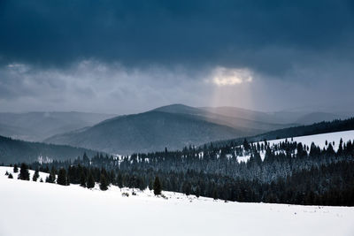 Scenic view of snow covered mountains against sky