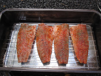 High angle view of fish on barbecue grill