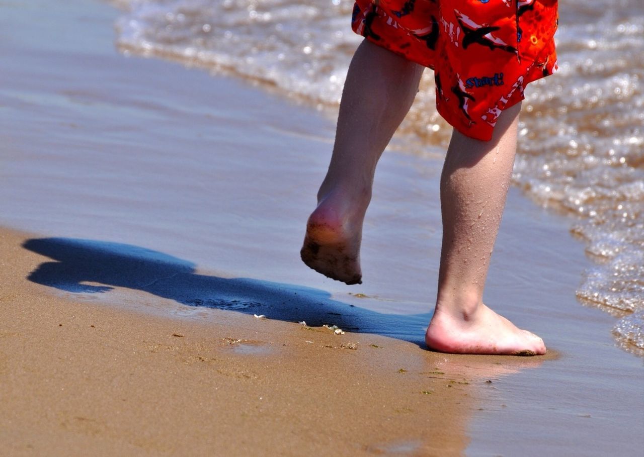 beach, low section, water, person, sea, shore, lifestyles, sand, leisure activity, barefoot, standing, vacations, wave, wet, human foot, motion