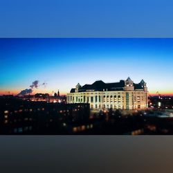 View of illuminated buildings against blue sky