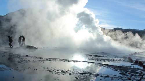 Smoke emitting from volcanic mountain against sky