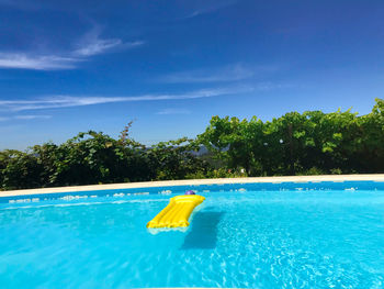 View of swimming pool against blue sky