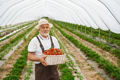 Full length of man standing in basket