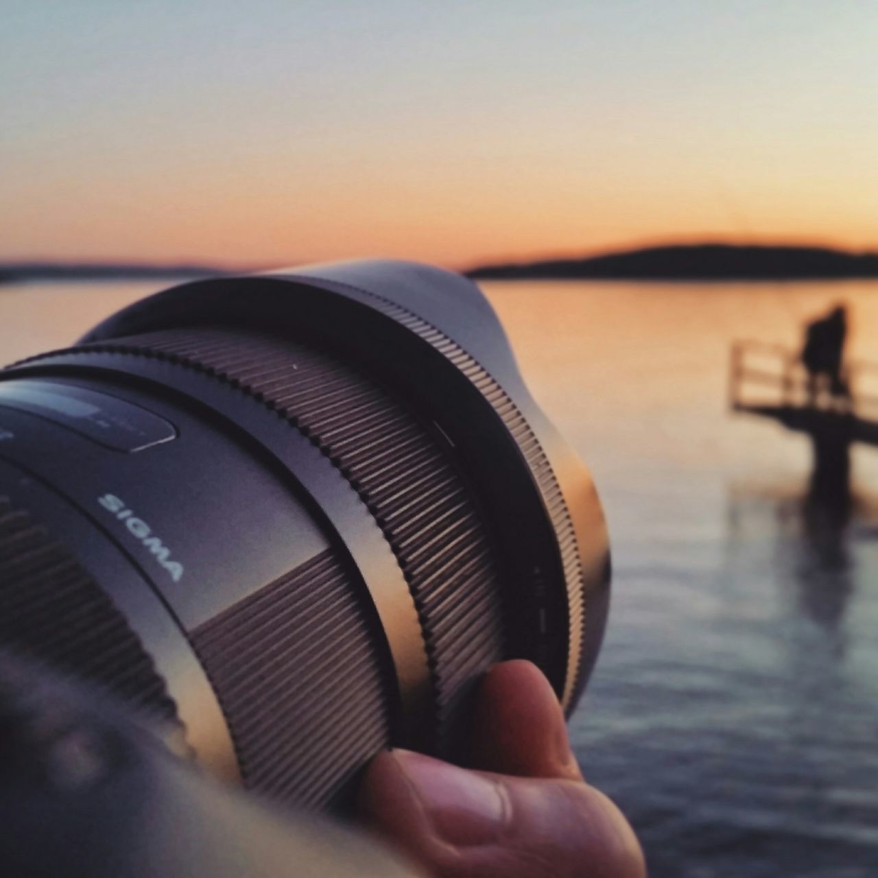 person, part of, personal perspective, cropped, holding, focus on foreground, lifestyles, leisure activity, unrecognizable person, human finger, men, sunset, close-up, sky, water, sea, clear sky