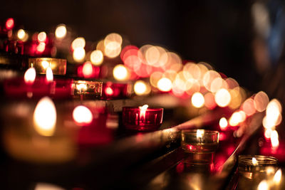 Close-up of illuminated candles in temple