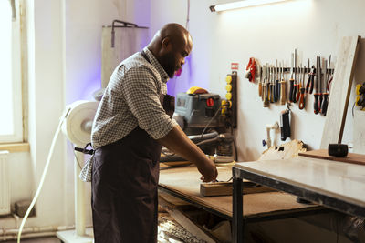 Rear view of man working in workshop