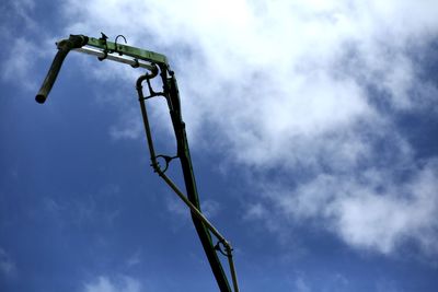 Low angle view of communications tower against blue sky