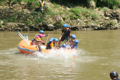 People on boat in river