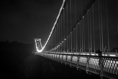 Low angle view of illuminated bridge against sky at night