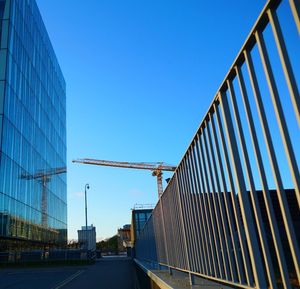 Low angle view of modern building against clear blue sky