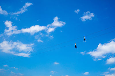 Low angle view of people ziplining