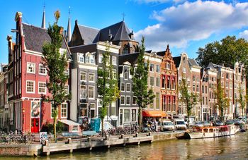 Boats in canal with buildings in background