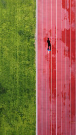 Person on field seen through window of building