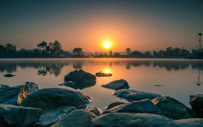 Scenic view of lake against sky during sunset