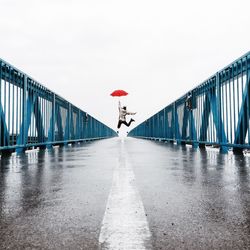 Woman walking on footbridge