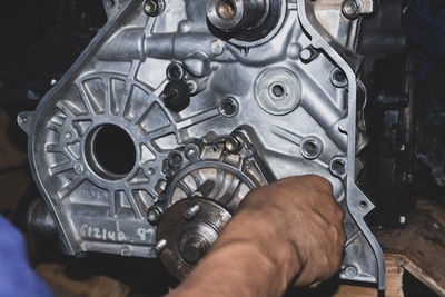 Cropped hand of man repairing car