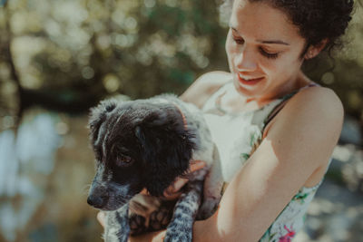 Smiling woman holding dog