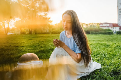 Rear view of woman standing on field
