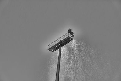 Low angle view of communications tower against sky
