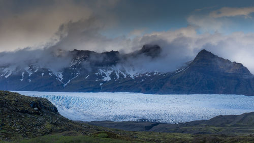 Scenic view of snowcapped mountains against sky