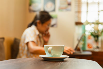 Young woman using mobile phone at home