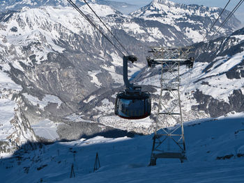 Overhead cable car on snowcapped mountains during winter