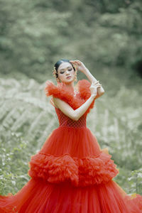 Portrait of young woman standing on field