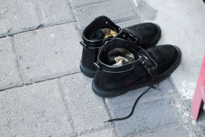 High angle view of black shoes on tiled floor