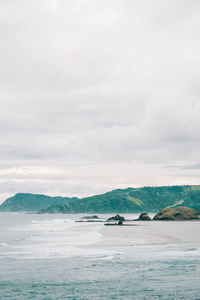 Scenic view of sea against cloudy sky