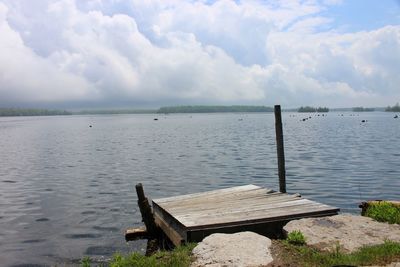 Pier over lake against sky