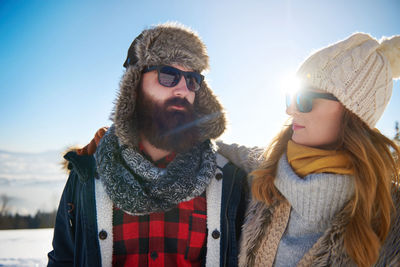 Young friends standing in warm cloth during winter