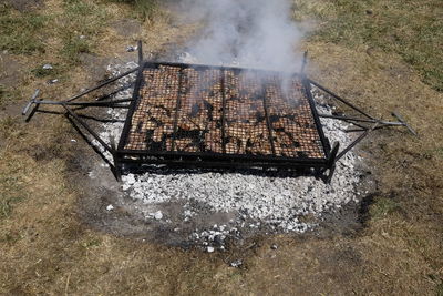 High angle view of barbecue grill on field