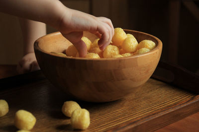 Close-up of person preparing food in bowl on table