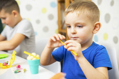 Close-up of boy eating food at home