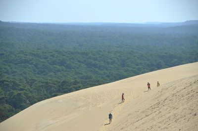 People on landscape against sky