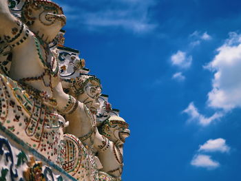 Low angle view of statue against blue sky