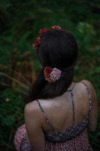 Rear view of woman with pink flower