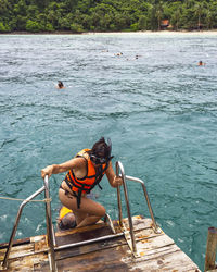 Man sitting on boat in sea