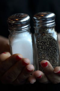 Close-up of woman hand holding glass jar