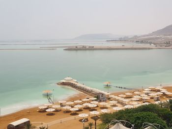 High angle view of sea and mountains against sky