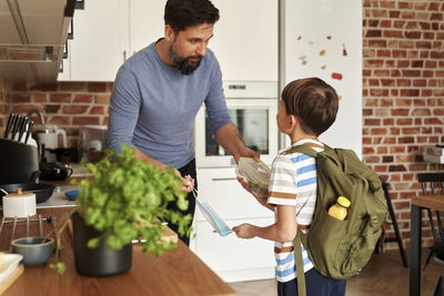 Side view of young man working at home