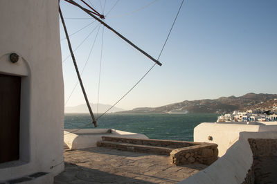 Scenic view of sea by buildings against clear sky