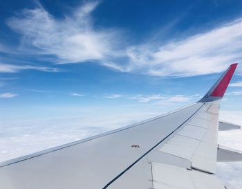 Cropped image of airplane wing against sky